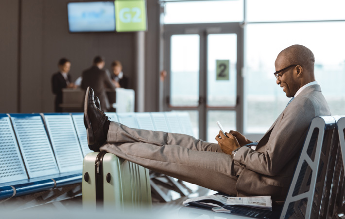 Airport passenger Businessman on the phone 710x450