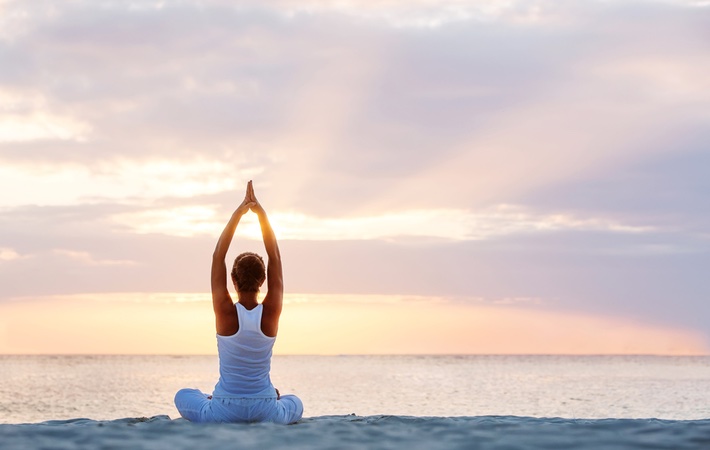 woman beach yoga wellness